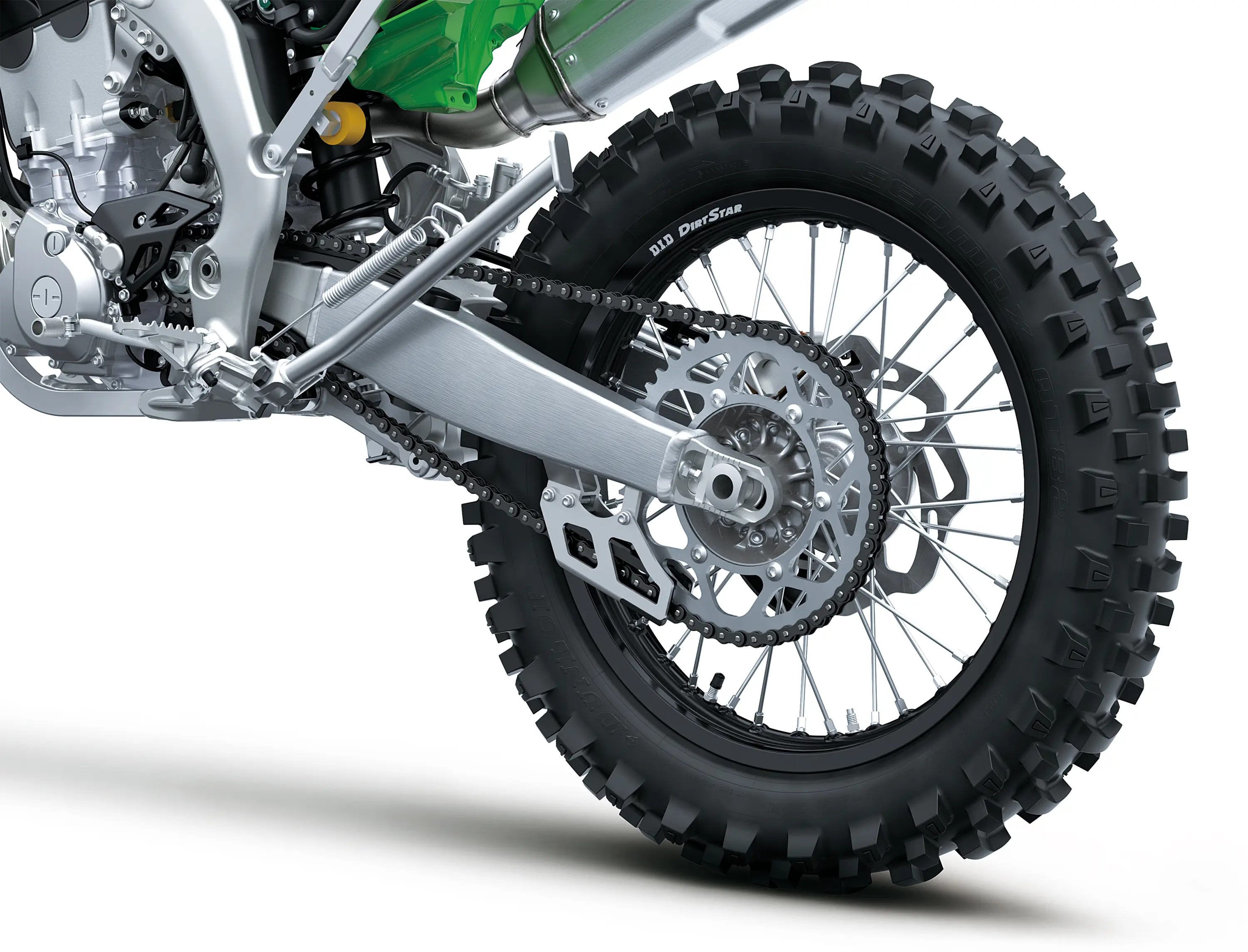 Close-up of the rear wheel of a motorcycle staged in a white studio background.
