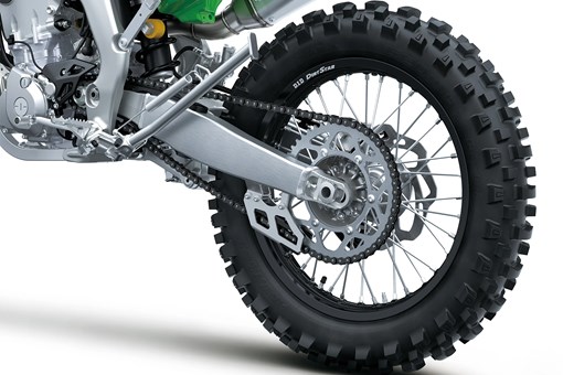 Close-up of the rear wheel of a motorcycle staged in a white studio background. opens in a new window