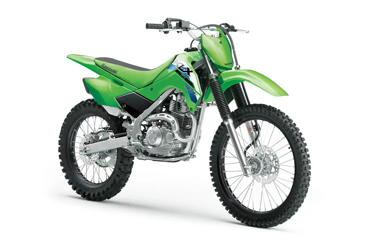Front three-quarter view of a green dirt bike in a white studio background.