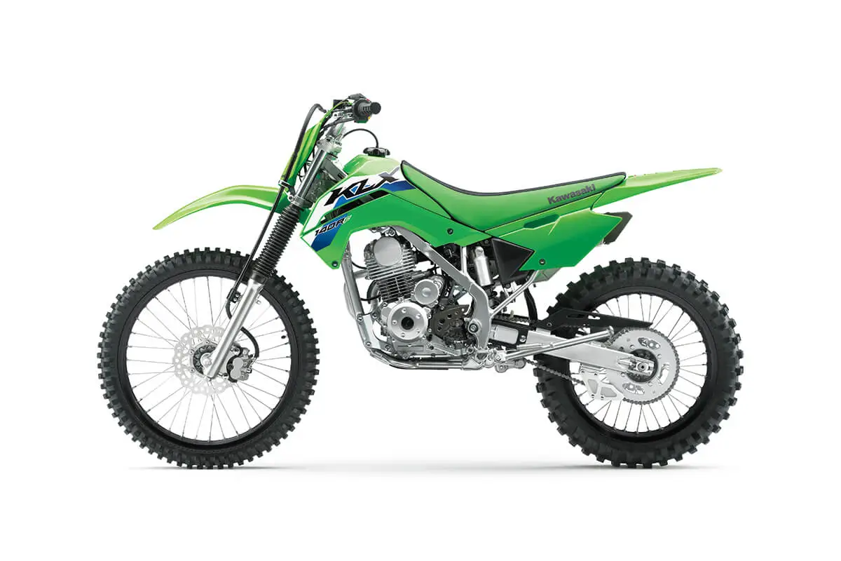 Left side view of a green dirt bike staged in a white studio background.