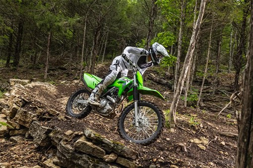Side angle of a person riding a motorcycle off-road. opens in a new window