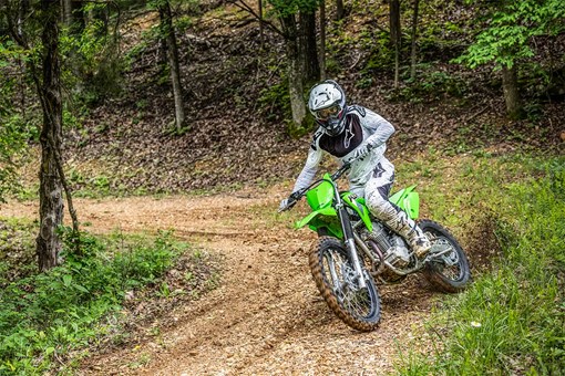 Three-quarter front angle of a person riding a motorcycle off-road. opens in a new window