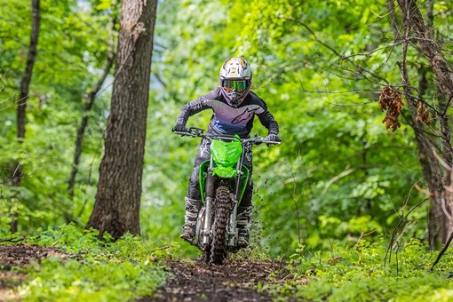 Front angle of a person riding a motorcycle off-road. opens in a new window