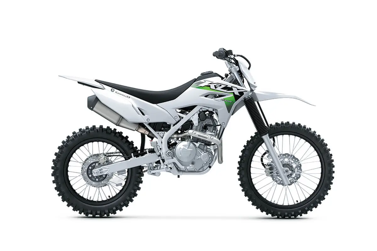Profile angle of a silver motorcycle staged in a white studio background.