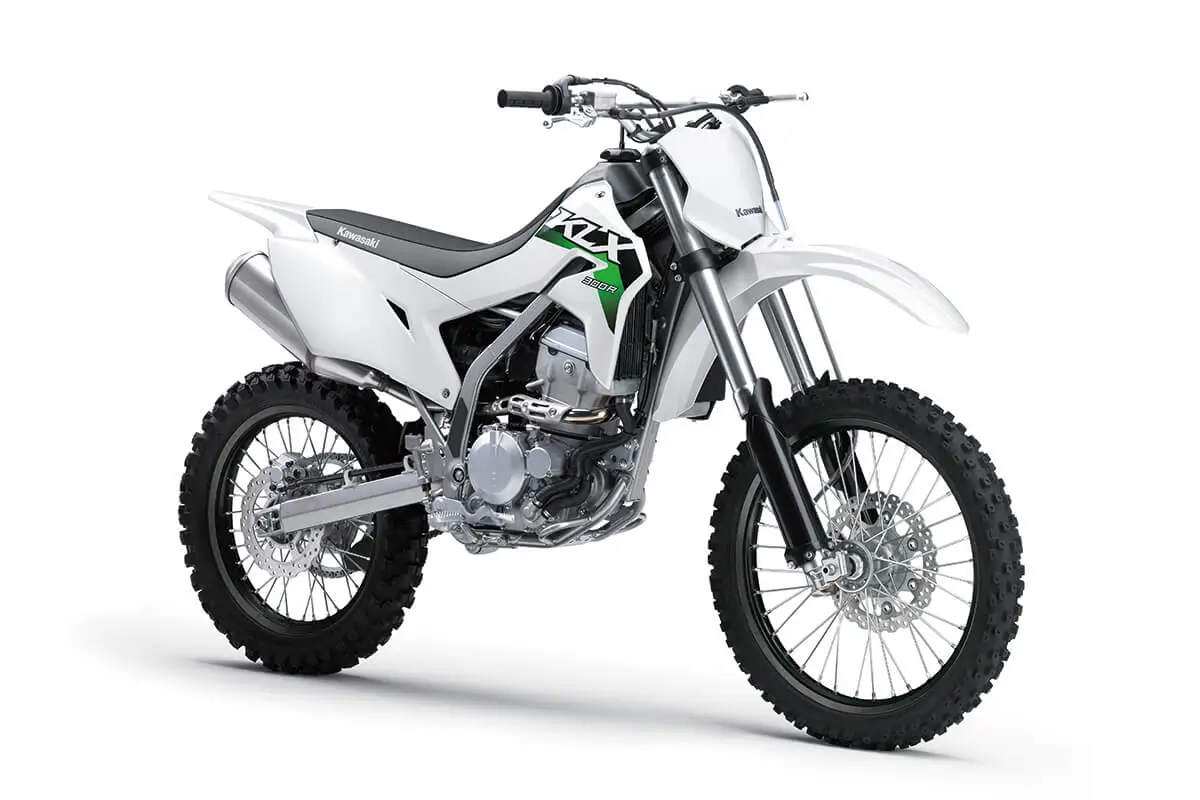 Front three-quarter view of a white dirt bike in a white studio background.