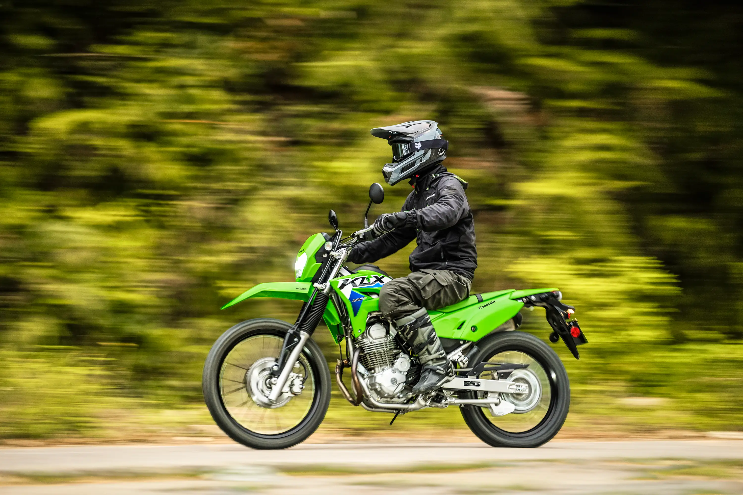 Profile angle of a person riding a motorcycle off-road.