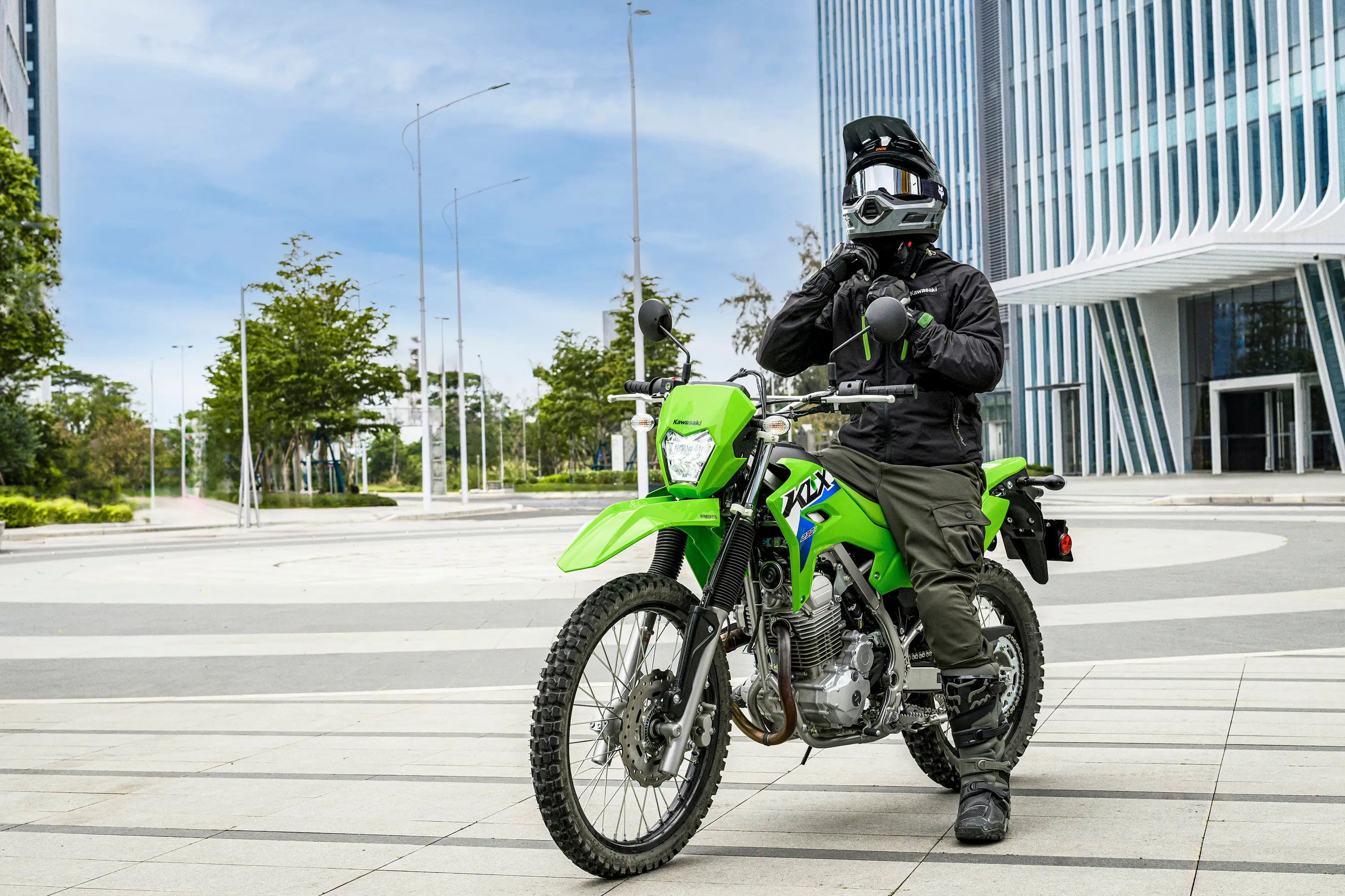 Three-quarter front angle of a person seated on a motorcycle.
