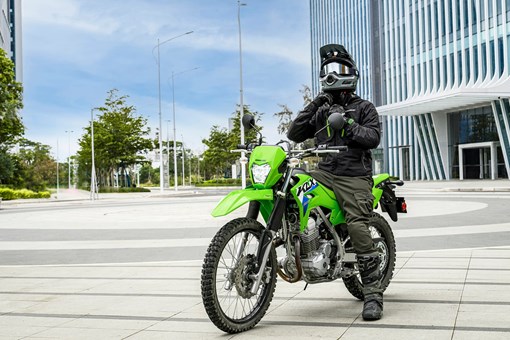 Three-quarter front angle of a person seated on a motorcycle. opens in a new window