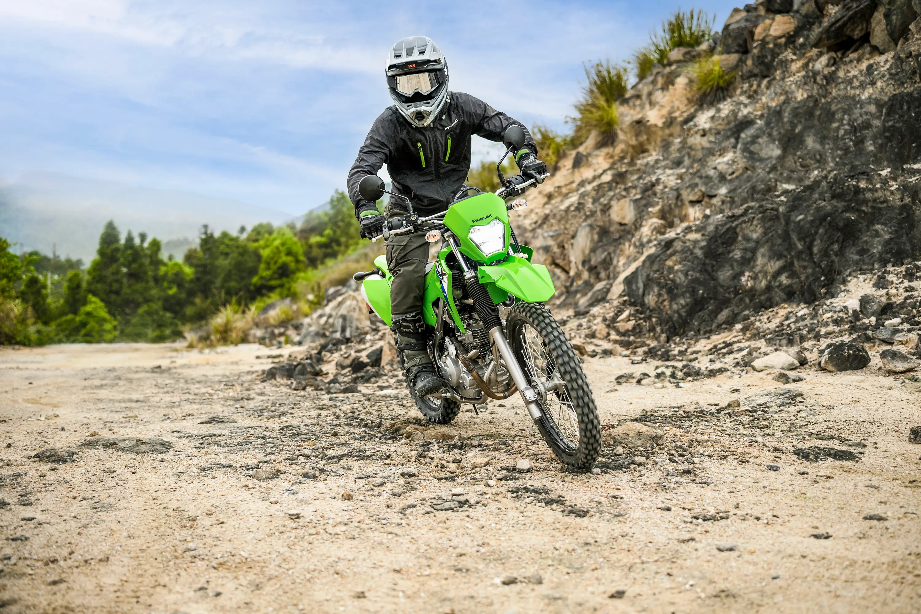 Front angle of a person riding a motorcycle off-road.