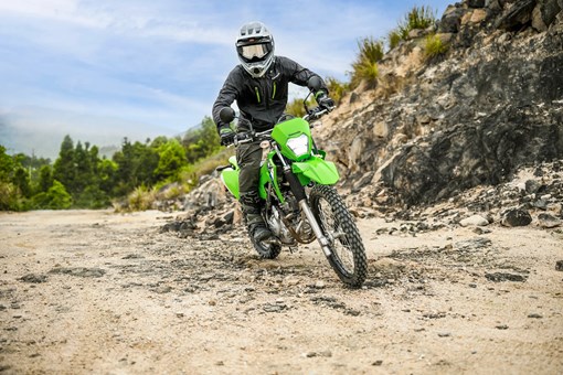 Front angle of a person riding a motorcycle off-road. opens in a new window