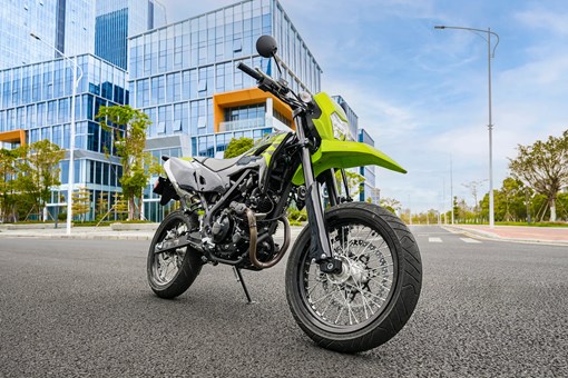 Three-quarter front angle of a motorcycle staged on a city street. opens in a new window