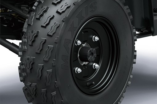 Detail view of a front wheel of a utility ATV in a white studio background. opens in a new window