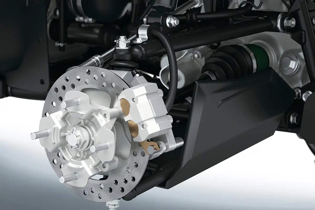 Detail view of the disc brakes of a utility ATV in a white studio background.