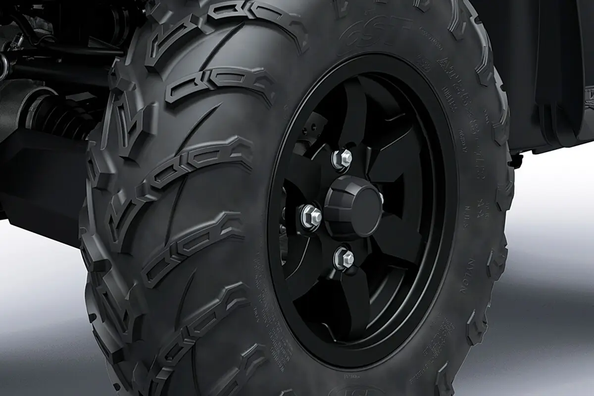 Detail view of a wheel of a utility ATV in a white studio background.
