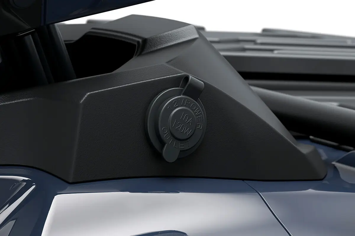 Detail view of a 12v outlet on a utility ATV in a white studio background.