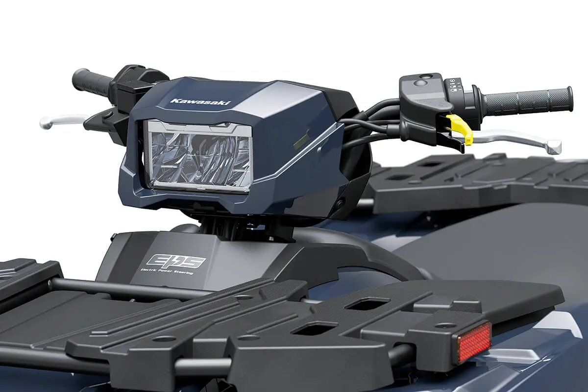 Detail view of the headlight of a utility ATV staged in a white studio background.