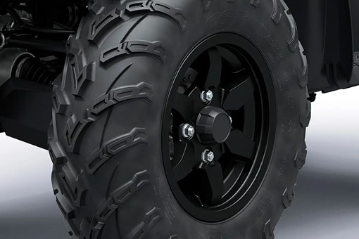 Detail view of a wheel of a utility ATV staged in a white studio background. opens in a new window