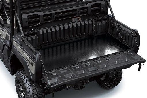 Cargo bed and tailgate of a side x side staged in a white studio background. opens in a new window