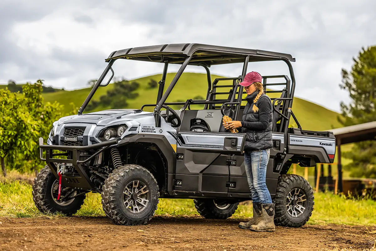 Person getting ready to get into a side x side on a dirt road.
