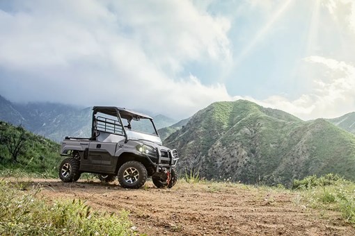 Three-quarter view of a side x side parked on a scenic hilltop. opens in a new window