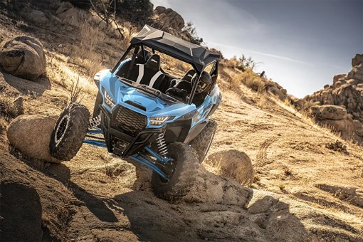 Front angle of a person riding a side x side off-road. opens in a new window