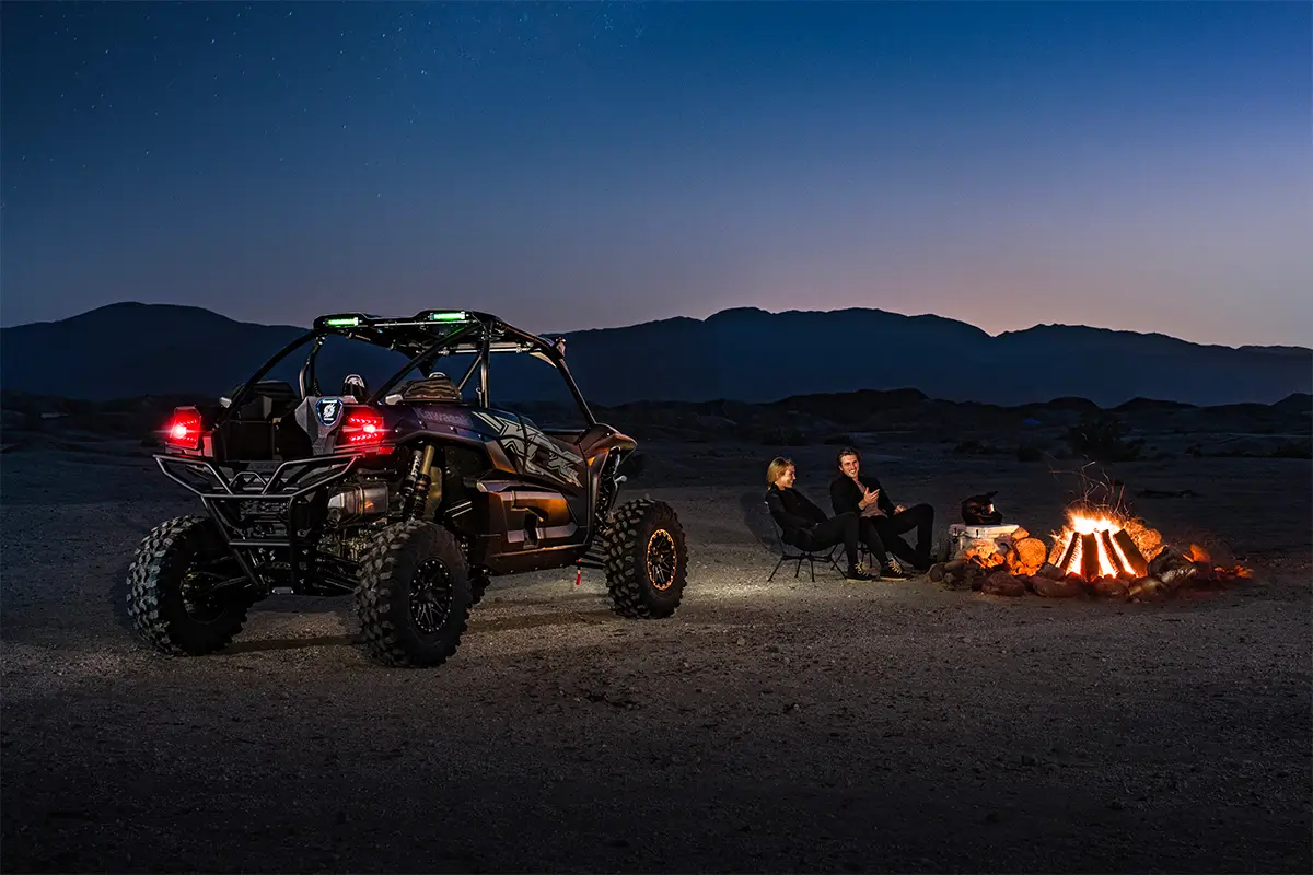 Three-quarter rear angle of a side x side parked off-road.