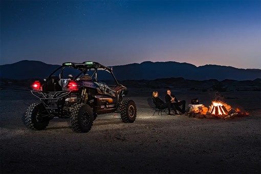 Three-quarter rear angle of a side x side parked off-road. opens in a new window