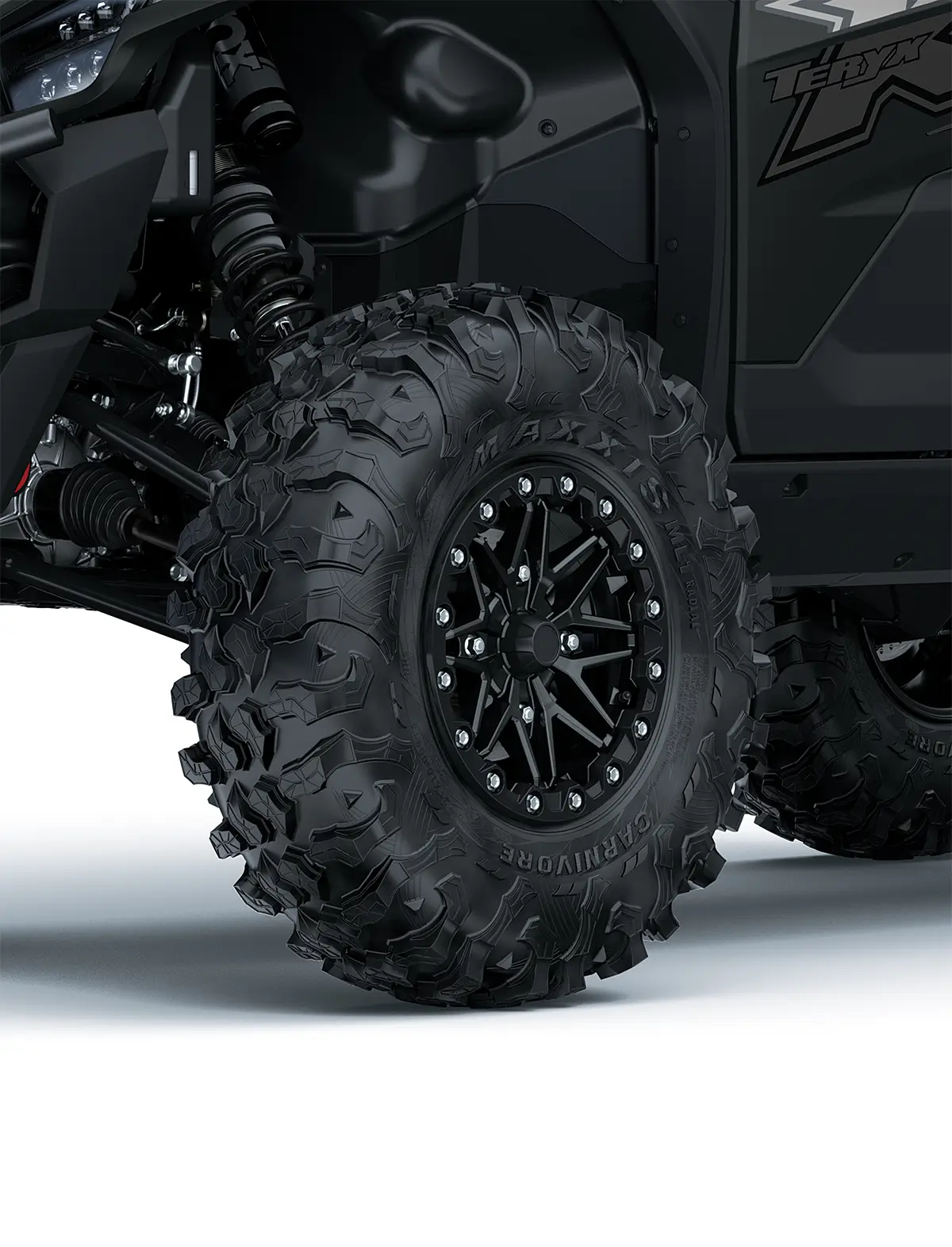 Close-up of the front-left wheel of a side x side staged in a white studio background.