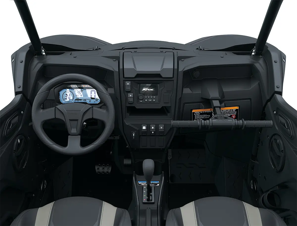 Interior POV of the steering wheel and dashboard of a side x side staged in a white studio background.