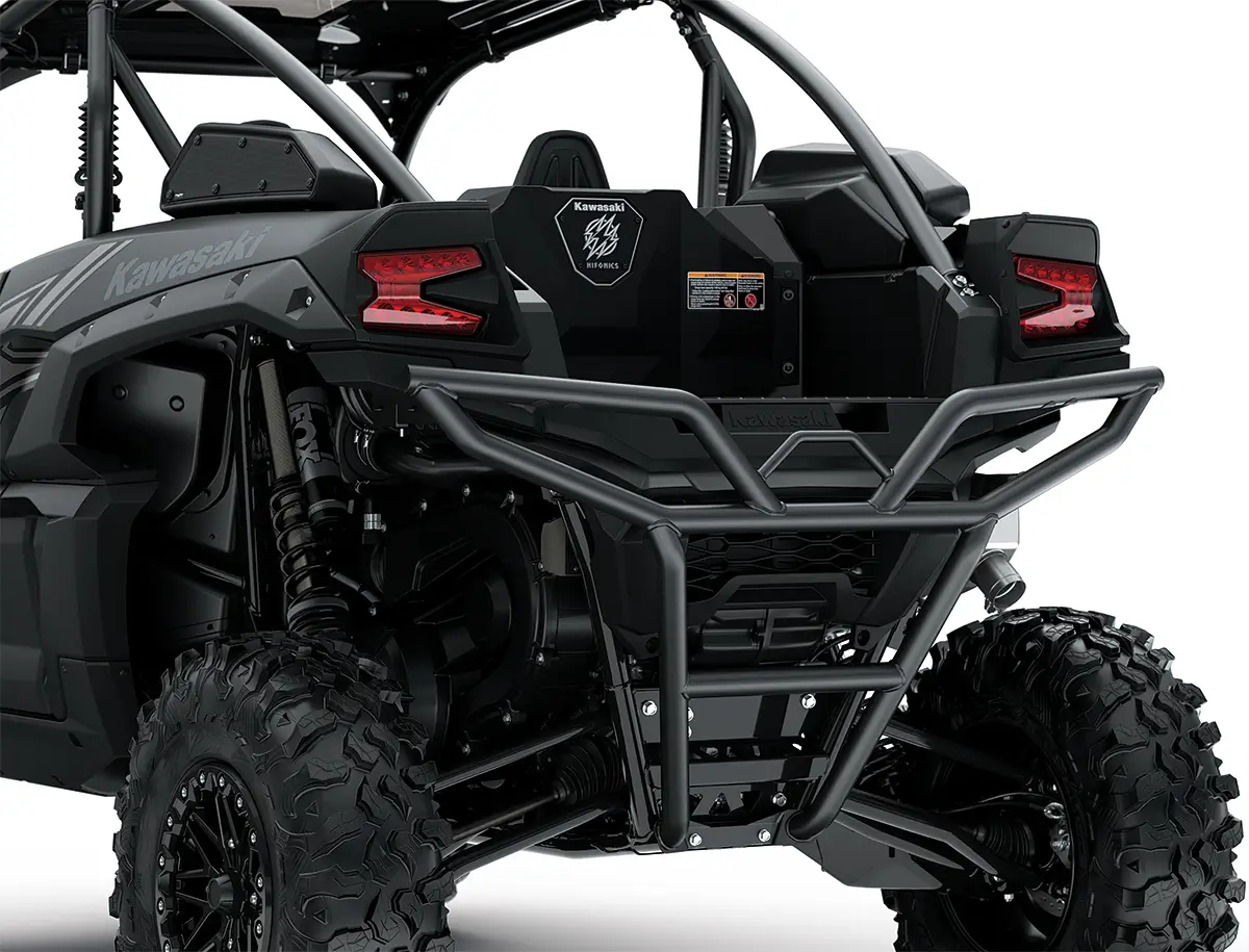 Close-up of the headlights and back end of a side x side staged in a white studio background.