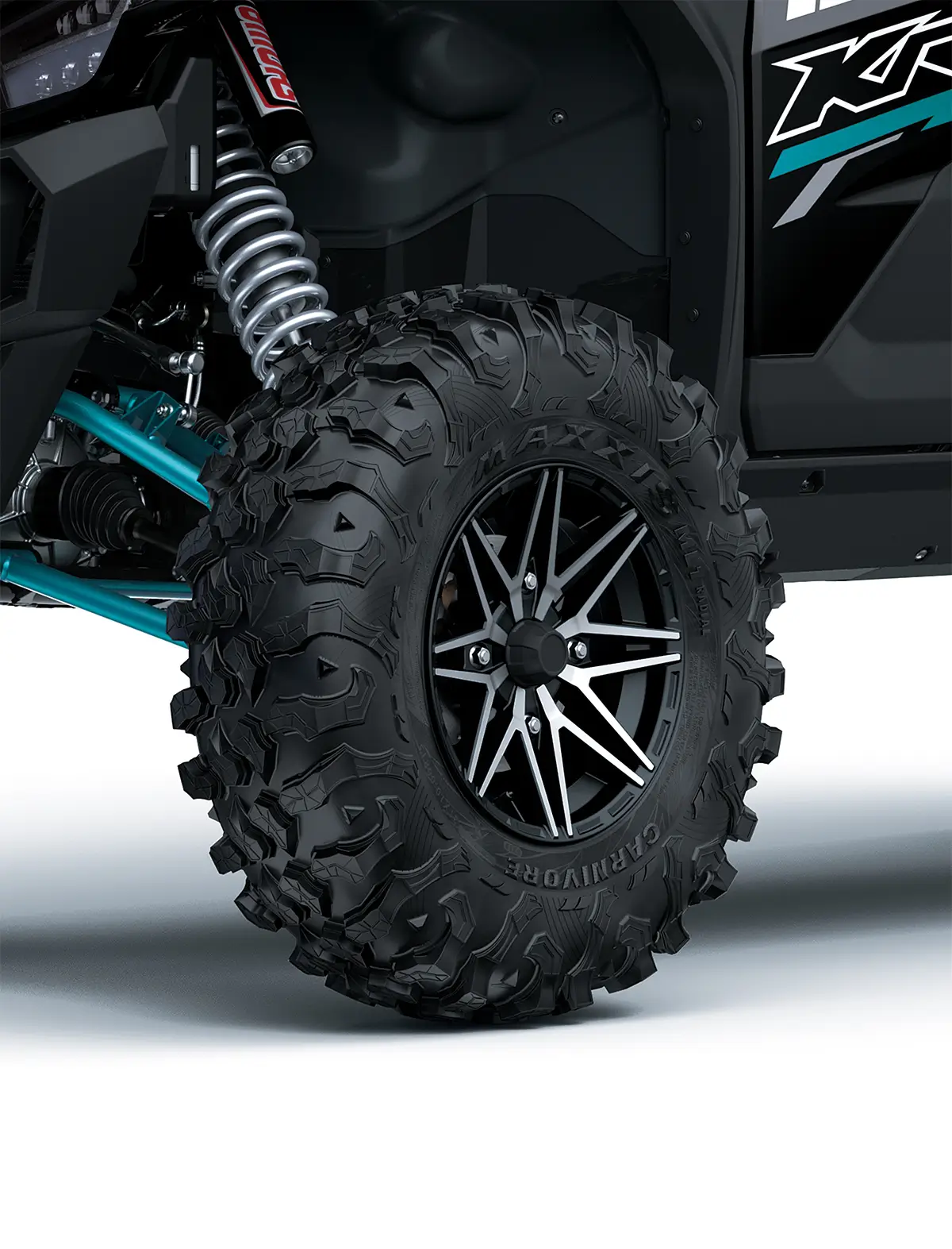 Close-up view of the front left tire of a side x side staged in a white studio background.