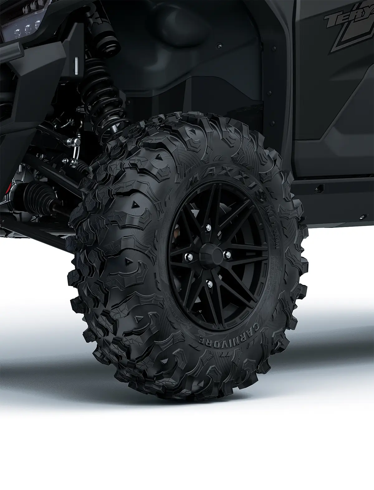 Close-up view of the front-left tire of a side x side staged in a white studio background.