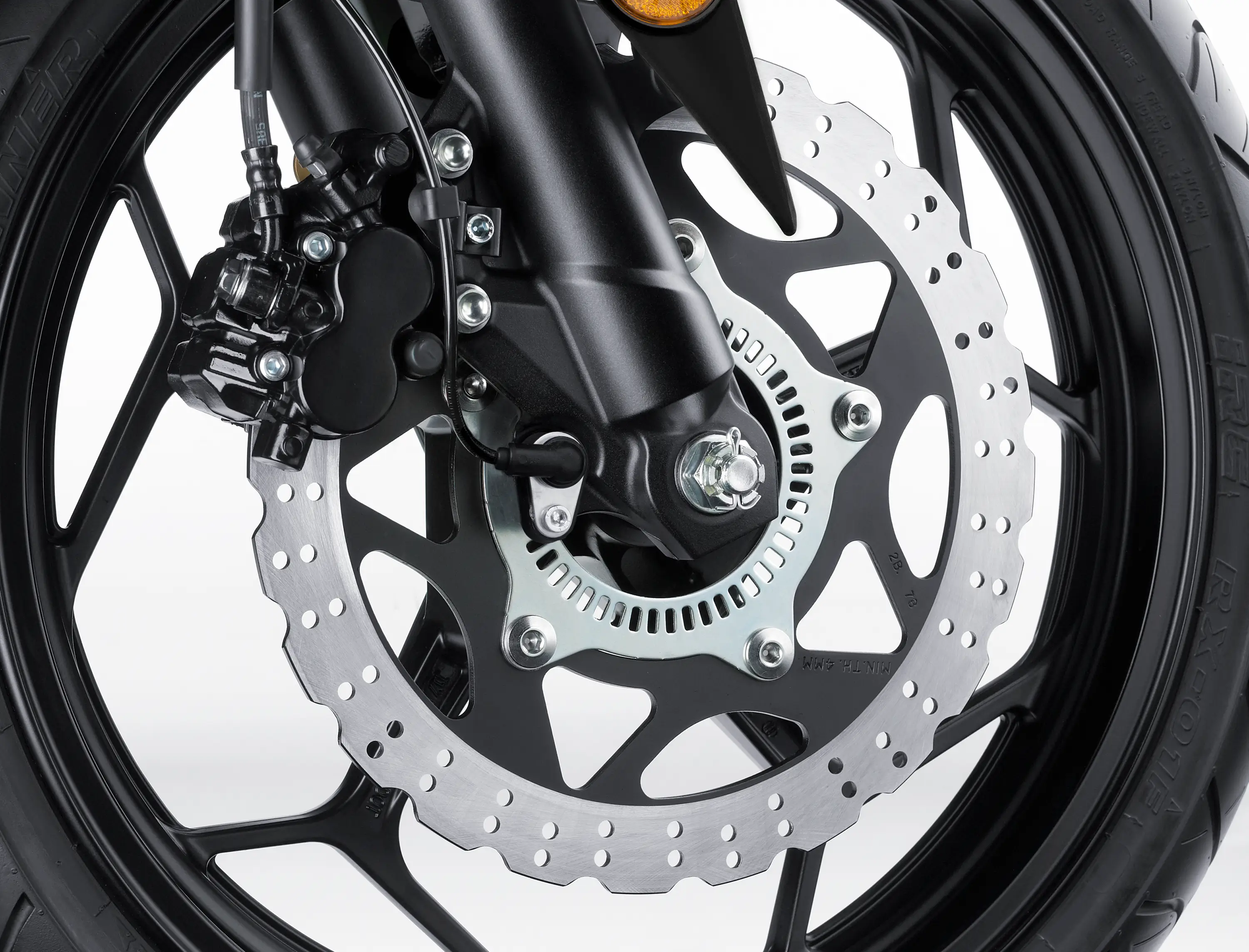 Close-up of the front brake assembly motorcycle staged in a white studio background.