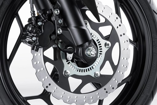 Close-up of the front brake assembly motorcycle staged in a white studio background. opens in a new window