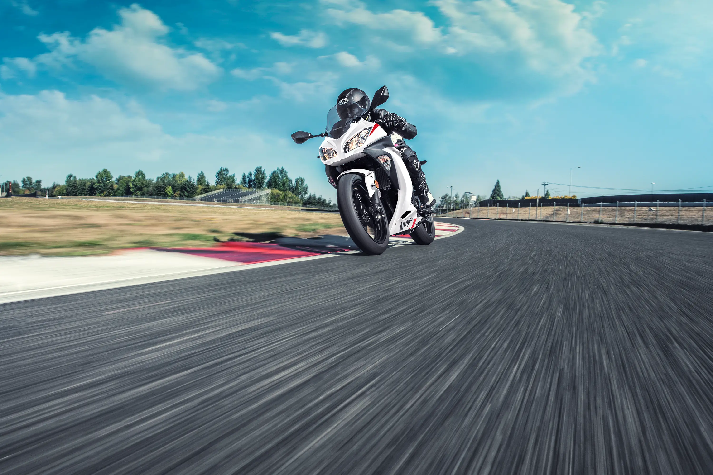 Front angle of a person riding a motorcycle on a track.