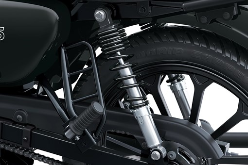 Close-up of the front shocks of a motorcycle staged in a white studio background. opens in a new window