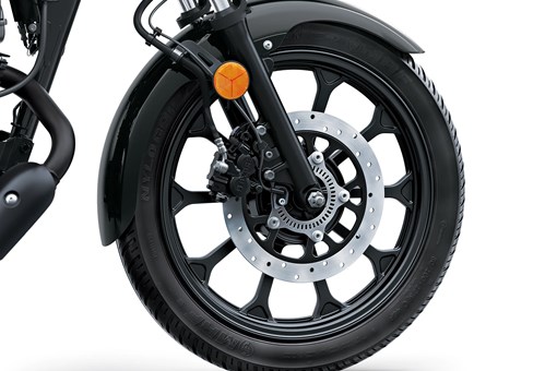 Close-up of the front wheel of a motorcycle staged in a white studio background. opens in a new window