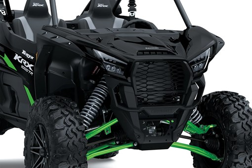 Close-up of the front end of a side x side staged in a white studio background. opens in a new window
