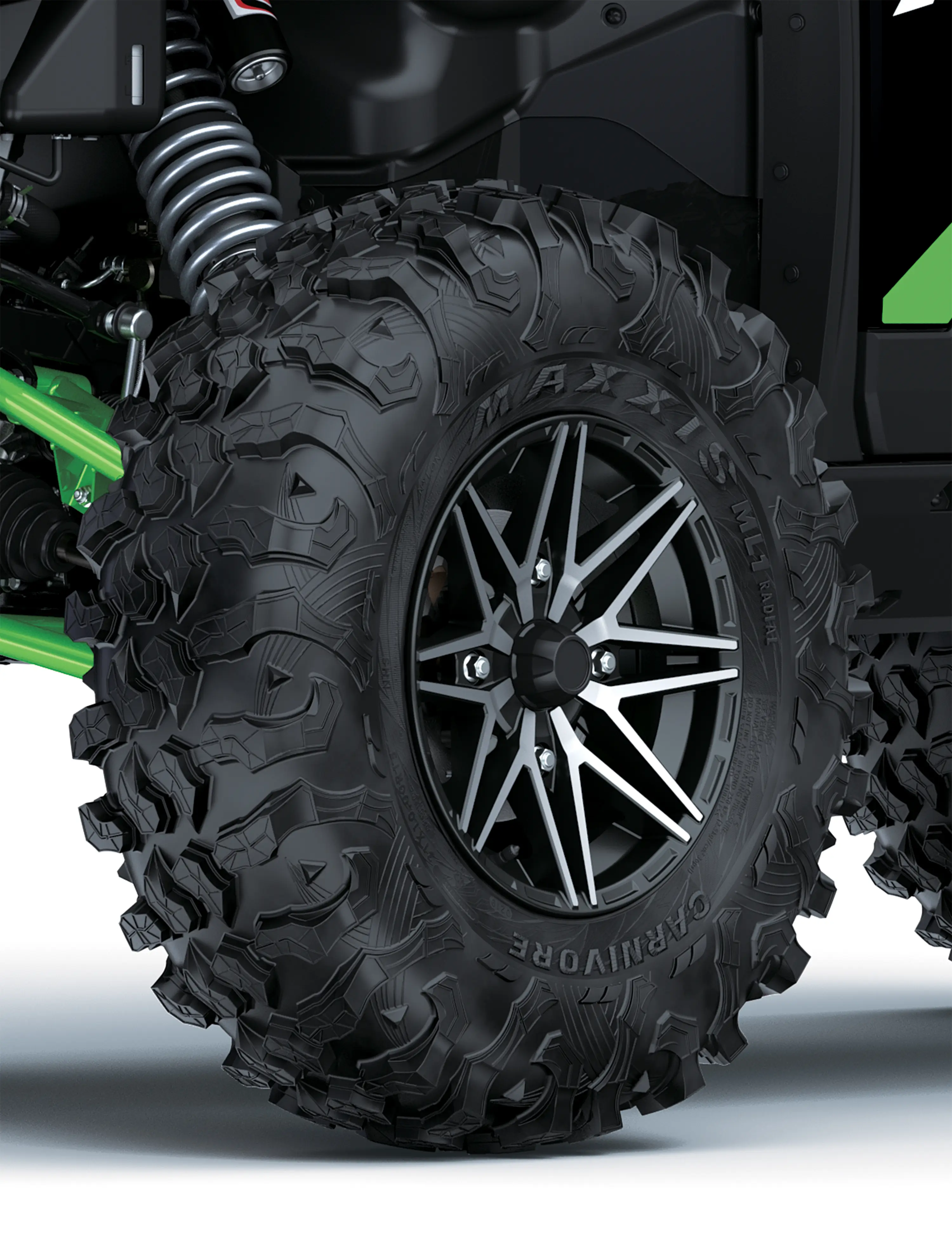 Close-up of a tire of a side x side staged in a white studio background.