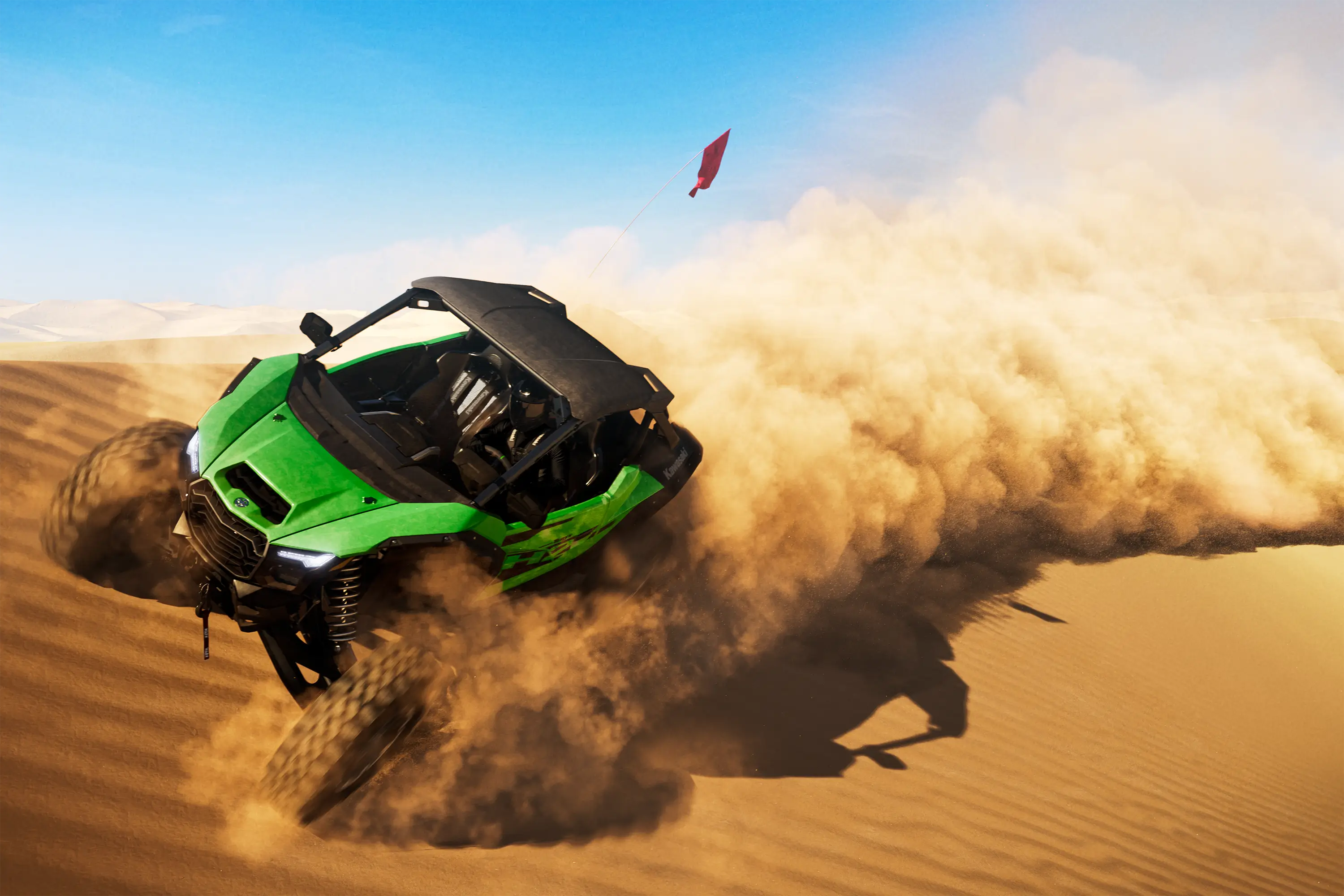 Three-quarter front angle of a person driving a side x side through sand dunes.