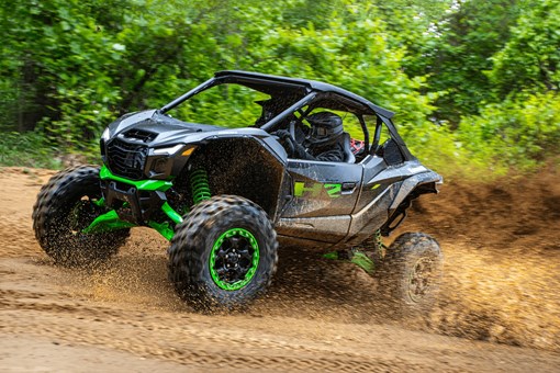 Side angle of a person driving a side x side uphill off-road. opens in a new window