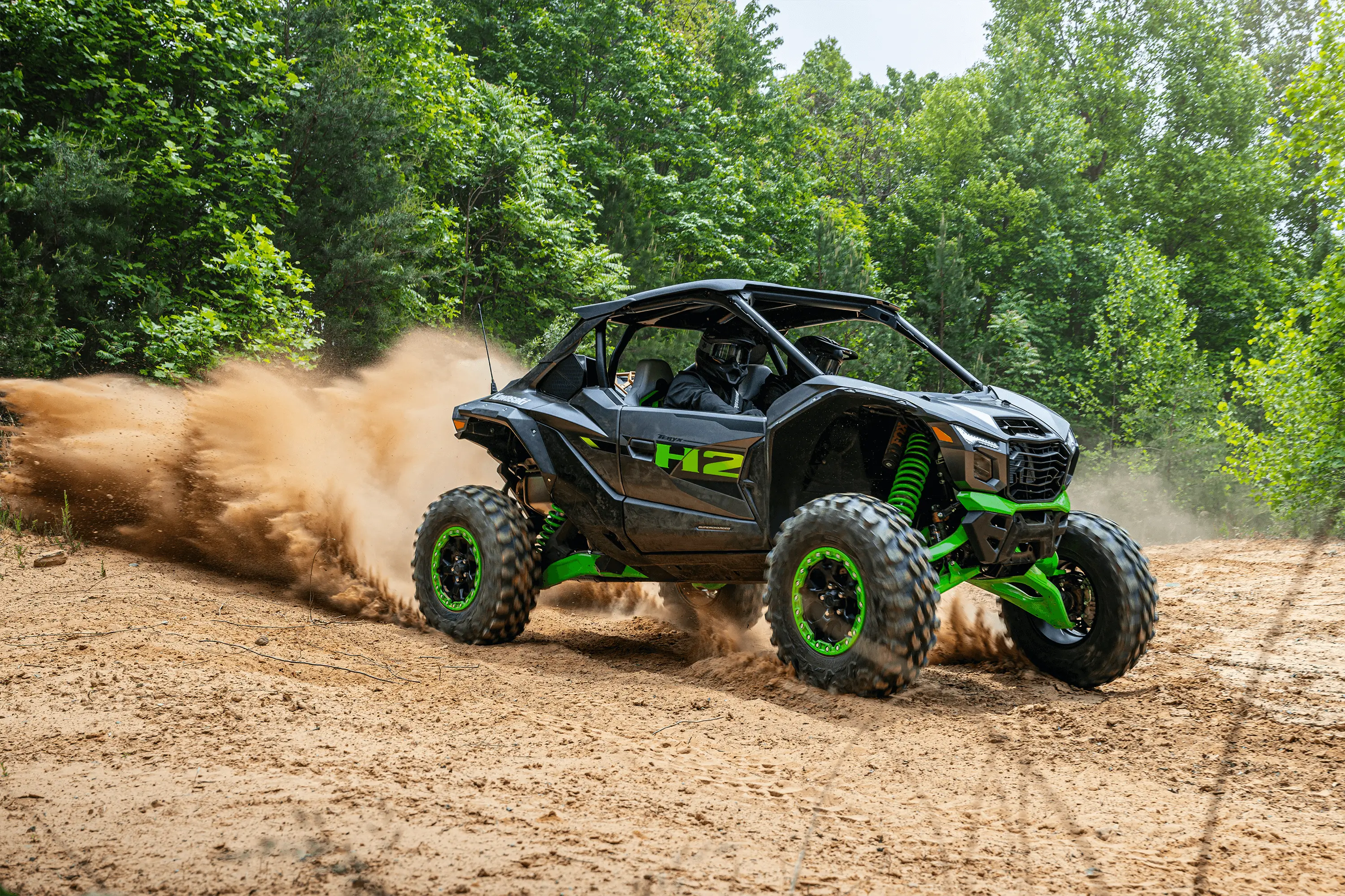 Side angle of a person driving a side x side off-road.