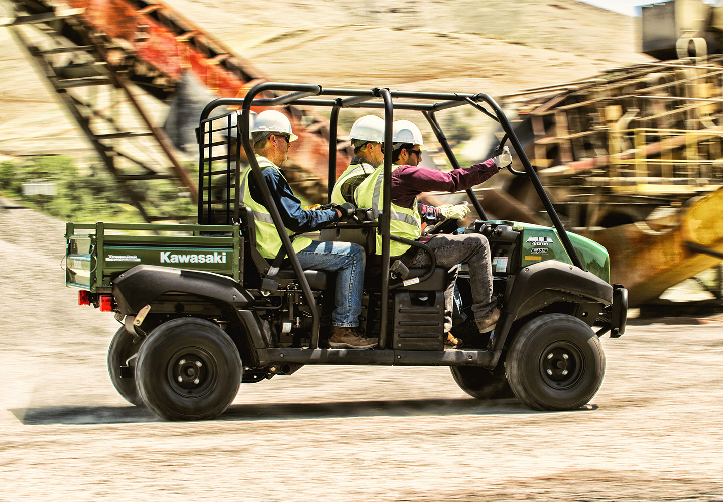 Mule with 4 workers driving through a job site