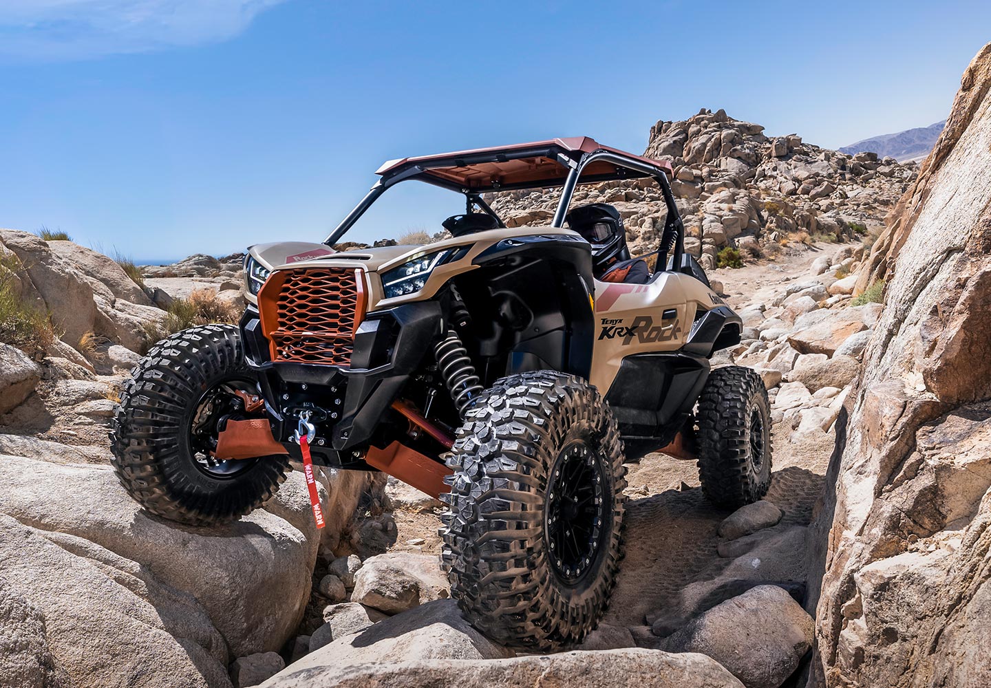 Teryx climbing over boulders
