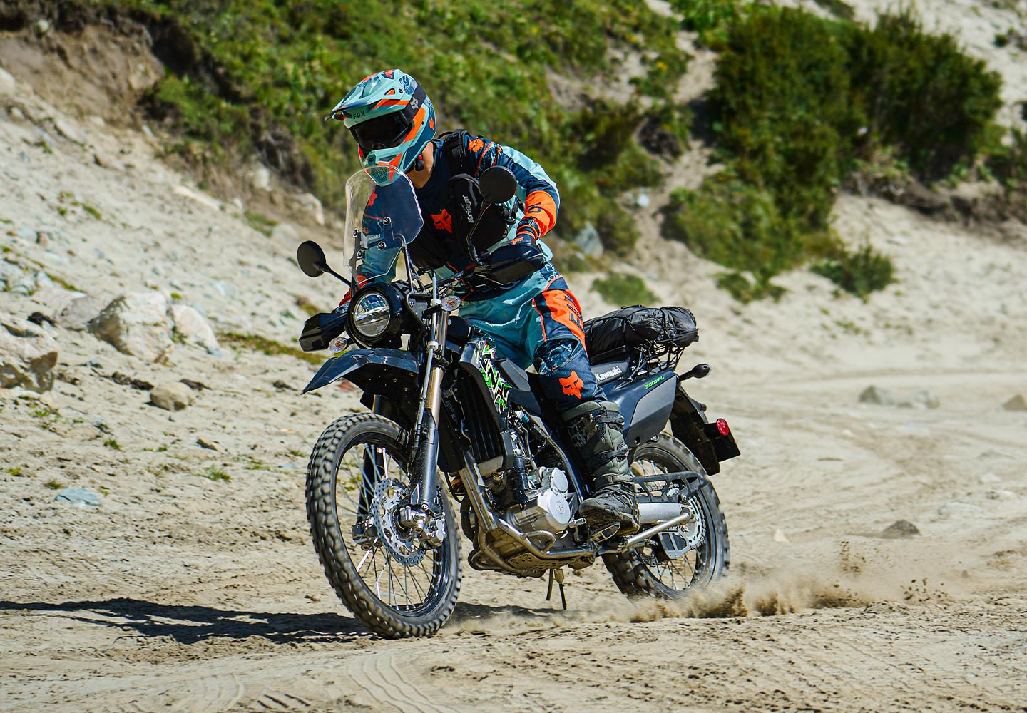 Image of a rider on a Kawasaki motorcycle on a dirt trail