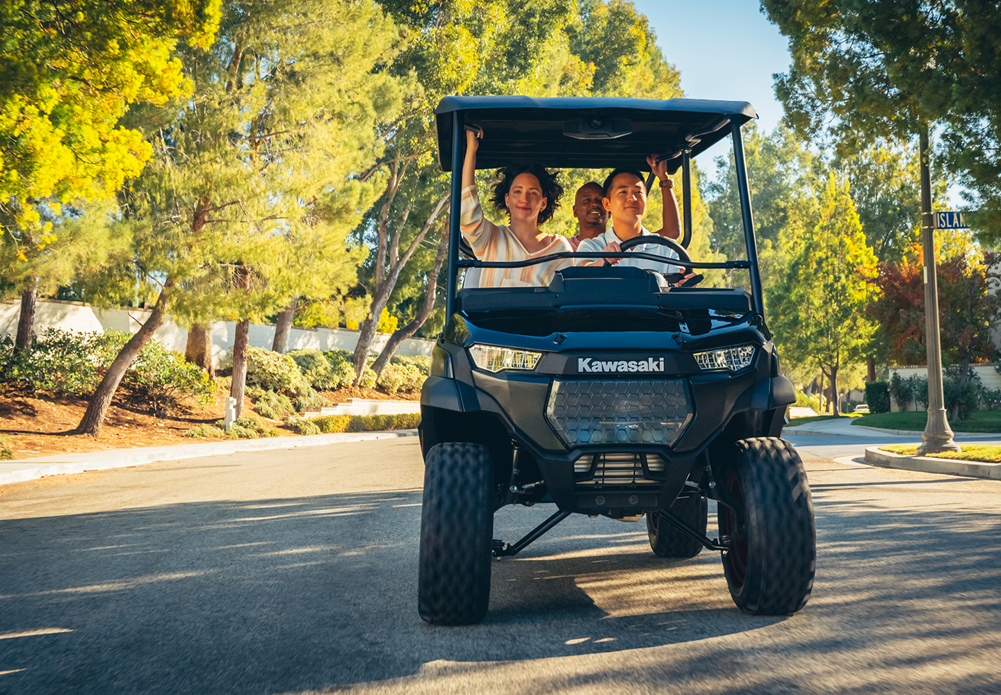 Three people cruising on a Neighborhood Activity Vehicle